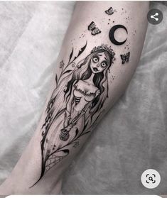 a woman's leg with a black and white tattoo design on the left thigh