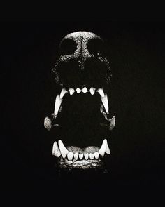 a black and white photo of a monster's mouth with its teeth wide open