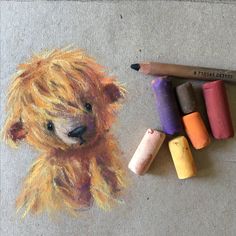 colored crayons next to a drawing of a teddy bear