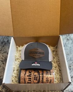 two hats in a box on top of a carpeted floor next to each other