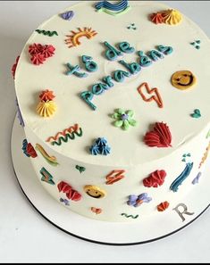 a white cake with colorful decorations on it