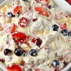 a white bowl filled with fruit salad on top of a table