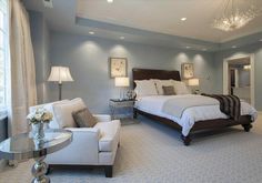 a bedroom with blue walls and carpeted flooring