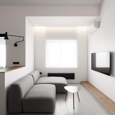 a modern living room with white walls and wood flooring