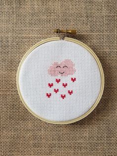 a cross stitch pattern with a cloud and hearts