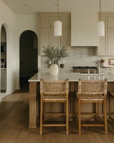 a kitchen with two chairs and an island