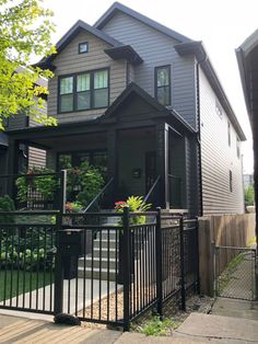 a house that has a black fence in front of it