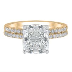 a yellow gold ring with a cushion cut diamond