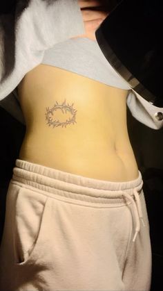 a person with a tattoo on their stomach