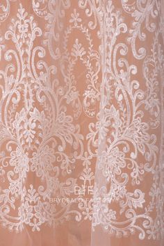 the sheer curtain with white lace on it