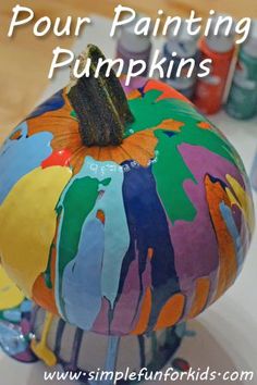 a painted pumpkin sitting on top of a table