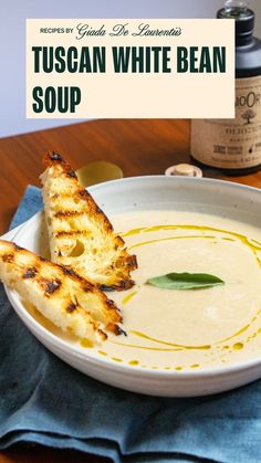 a white bowl filled with soup on top of a wooden table