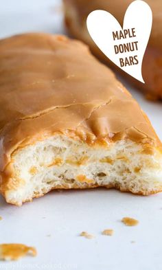 two glazed donuts sitting on top of a white surface