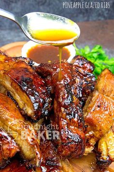 barbecue ribs with sauce being drizzled over them