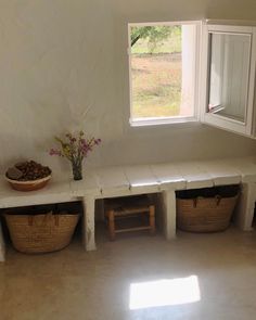 a room with some baskets and flowers in it