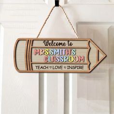 a wooden sign hanging from the side of a door that says welcome to mrs smith's classroom teach love inspire