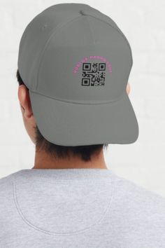 the back of a man wearing a gray hat with qr code on it's side