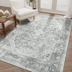 a large rug with an ornate design in grey and white