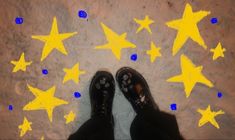 a person standing in front of yellow stars on the ground