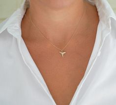 Gold Shark Tooth Pendant Necklace - Real Fossilized Tooth Our most popular single-layer shark tooth necklace! This simple, dainty gold shark tooth necklace is a must-have for any beach lover. The necklace features a real fossilized shark tooth found by Foxy Fossils in Charleston, SC making each one completely different and exclusive. The tooth is delicately hand-painted with several layers before placed on a dainty, elegant gold-filled chain that will not fade or tarnish over time. This necklace Shark Tooth Necklace Diy, Shark Teeth Jewelry, Shark Jewelry, Shark Tooth Pendant, Tooth Charm, Tooth Pendant, Surf Jewelry, Shark Necklace, Teeth Shape