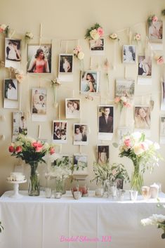 a table topped with pictures and vases filled with flowers