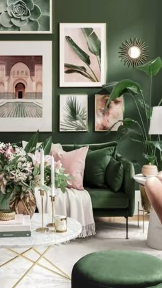 a living room with green walls and pictures on the wall above the couch, coffee table