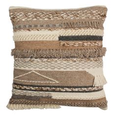 a brown and white pillow with fringes on it