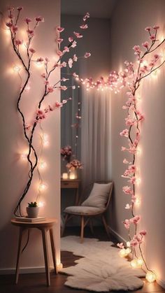 a room decorated with pink flowers and lights in the shape of a twig tree