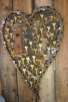 an old rusty heart hanging on a wooden wall