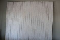 a white wooden paneled wall in an empty room