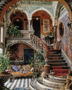 an elaborately decorated staircase leads up to the second floor in this ornate home with tiled floors and walls