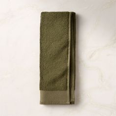 an olive green towel on a white background