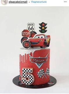 a red and white cake with cars on it