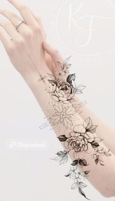 a woman's arm with flowers on it and a hand holding the wrist tattoo