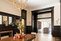 a dining room table with chairs and a chandelier