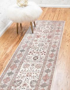 a white rug sitting on top of a hard wood floor next to a wooden chair