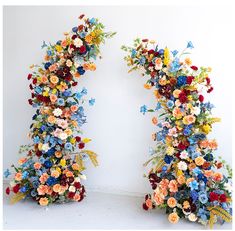 two archways made out of flowers and butterflies