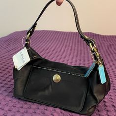 Coach Nwt Black Hobo Shoulder Bag. Blue Interior. Original Blue Coach Leather Purse Tags New With Tags Attached Very Good Condition- Never Used, No Stains! Please Note: Some Signs Of Wear From Being In Storage Please See Photos. (Small Distressed Areas) Approx. 9”Long X5” Tall X4” Deep Hand Or Shoulder Purse Zipper Closure, Inside And Outside Pockets Chic Coach Shoulder Bag With Snap Closure, Elegant Shoulder Bag With Snap Closure For On-the-go, Coach Shoulder Bag With Snap Closure, Coach Satchel With Snap Closure, Coach Blue Shoulder Bag For Shopping, Snap Closure Hobo Bag For On-the-go, Coach Blue Shoulder Bag With Removable Pouch, Black Coach Shoulder Bag In Coated Canvas, Blue Coach Bag With Zipper Closure