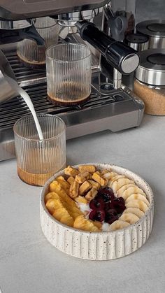 a pie sitting on top of a counter next to some cups and an espresso machine