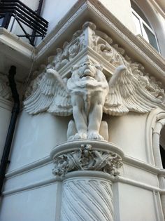 an angel statue on the side of a building