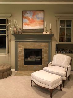 a living room filled with furniture and a fire place in front of a painting on the wall