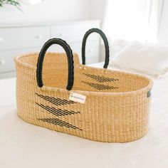 two baskets sitting on top of a bed