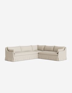 a white sectional couch sitting on top of a white floor