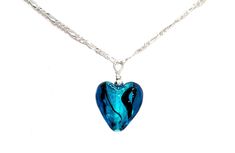 "~ Contemporary Murano Glass Lampwork Small Heart Pendant Necklace ~ Pendant is 5/8\" wide  x 3/4\" height (height includes bead and wire loop), puffed to a depth of 1/4\" ~ Semi-translucent aqua blue foil core shimmer with black ribbon swirls   ~ Pendant is uniquely created, no two exactly alike!  Yours will look very similar to the one pictured with slight variations. ~ .529 Sterling Silver bead and loop for pendant  ~ .529 Sterling Silver Figaro Chain with Lobster Clasp ~ Arrives in a white s Blue Necklace With Heart Charm, Blue Necklace With Round Heart Charm, Blue Necklaces With Heart Charm And Round Shape, Blue Glass Heart Beads Jewelry, Blue Glass Jewelry With Heart Beads, Blue Adjustable Necklace For Valentine's Day, Adjustable Blue Necklace For Valentine's Day, Adjustable Blue Necklaces For Valentine's Day, Nickel-free Blue Heart Necklaces