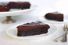 two plates with slices of chocolate cake on them