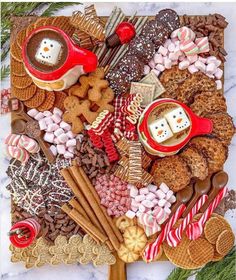 a platter filled with cookies, marshmallows and other holiday food items