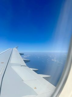 the wing of an airplane as seen from above on a clear day with blue skies