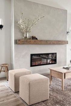 a living room filled with furniture and a fire place in the middle of the room