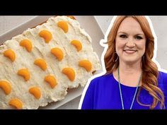 a woman standing next to a cake with orange icing on it and an image of the cake