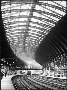 the inside of a train station with many tracks